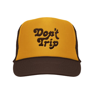 Don't Trip brown and gold trucker hat with brown embroidery on a white background