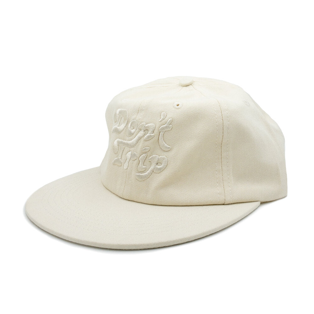 Don't Trip cream hat with white embroidered Don't Trip logo on white background - Free & Easy